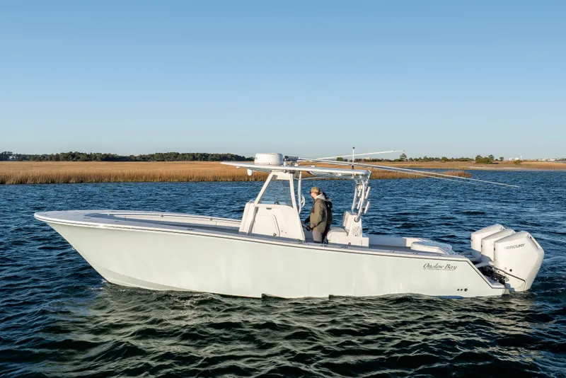 Slide: The Image of 2024 Onslow Bay 33 TE boat cruising on a calm lake with clear blue skies. - 9