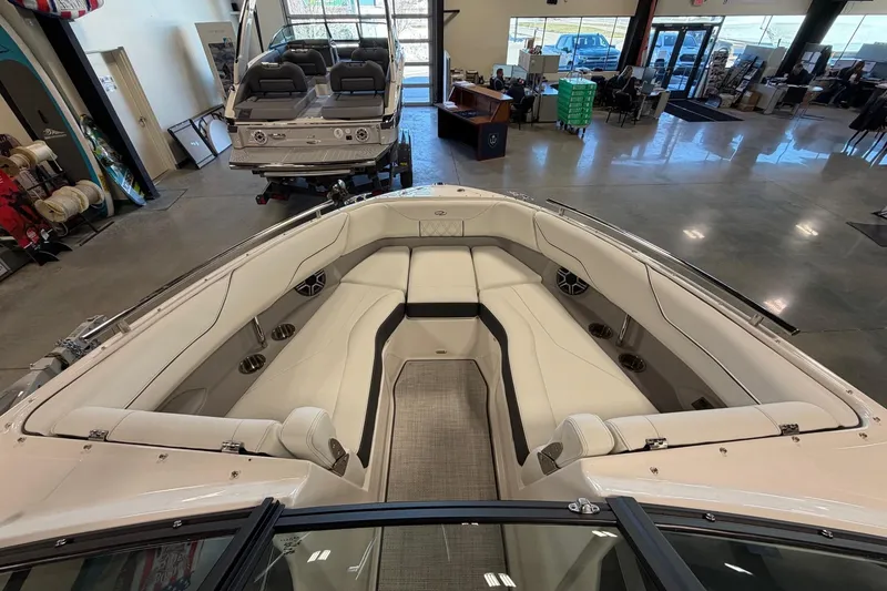 Slide: The Image of 2026 Regal LS4 boat interior with luxurious seating and modern design in showroom. - 14