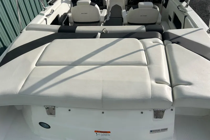 Slide: The Image of 2016 Larson LX 205S IO boat interior with white cushioned seating. - 11