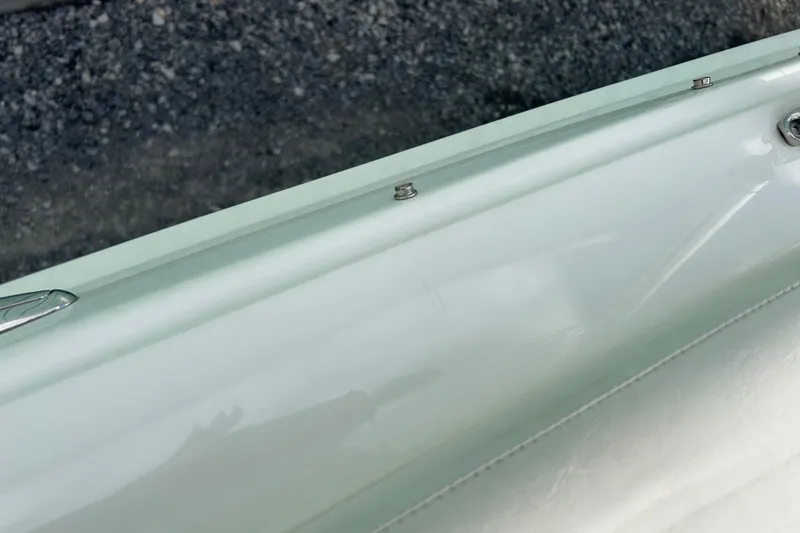 Slide: The Image of Close-up of 2016 Larson LX 205S IO boat's sleek white exterior detail. - 13