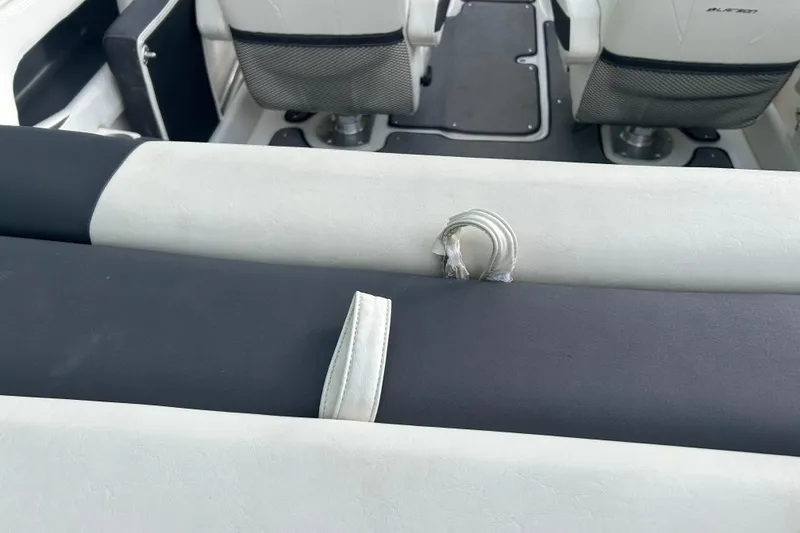 Slide: The Image of Interior of 2016 Larson LX 205S IO boat with white and black seating. - 14