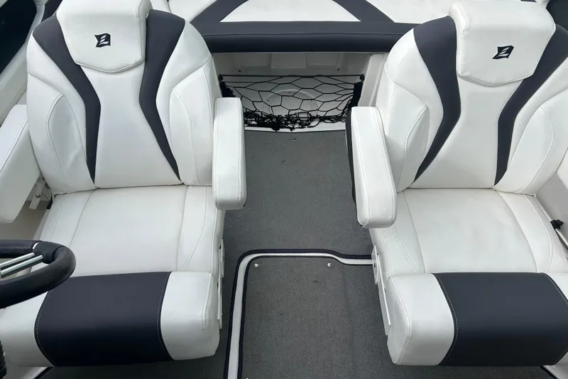 Slide: The Image of 2016 Larson LX 205S IO boat interior with white and black seats. - 16