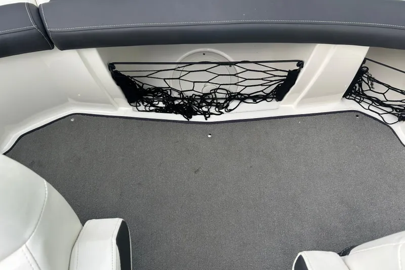 Slide: The Image of Interior of 2016 Larson LX 205S IO boat with seating and storage net. - 18