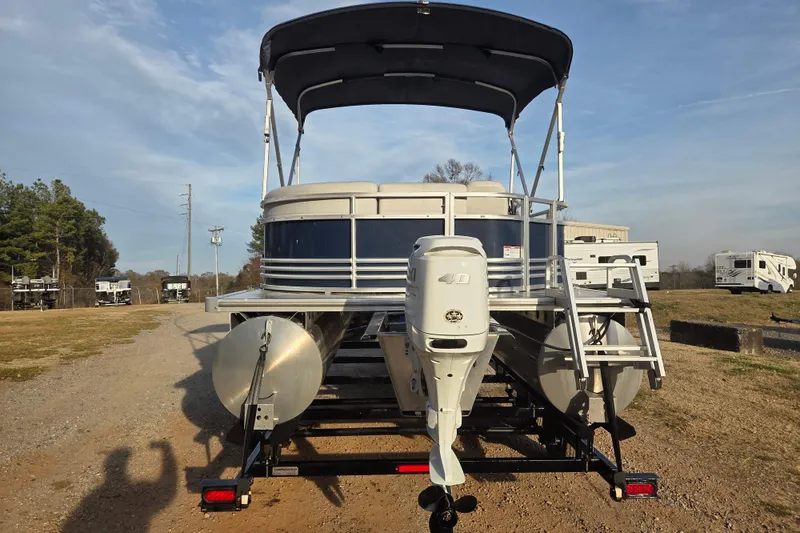 Slide: The Image of 2022 Nepallo 20TL pontoon boat with canopy and outboard motor on a trailer. - 2