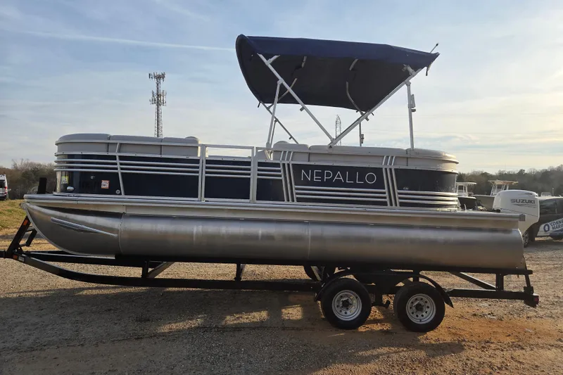 Slide: The Image of 2022 Nepallo 20TL pontoon boat on trailer with canopy, parked outdoors. - 4