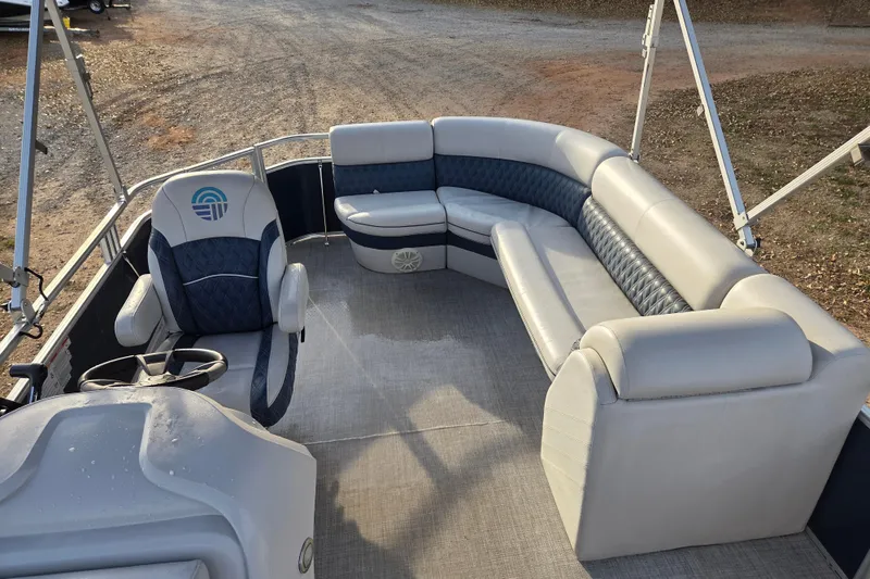 Slide: The Image of 2022 Nepallo 20TL pontoon boat interior with plush seating and steering console. - 7