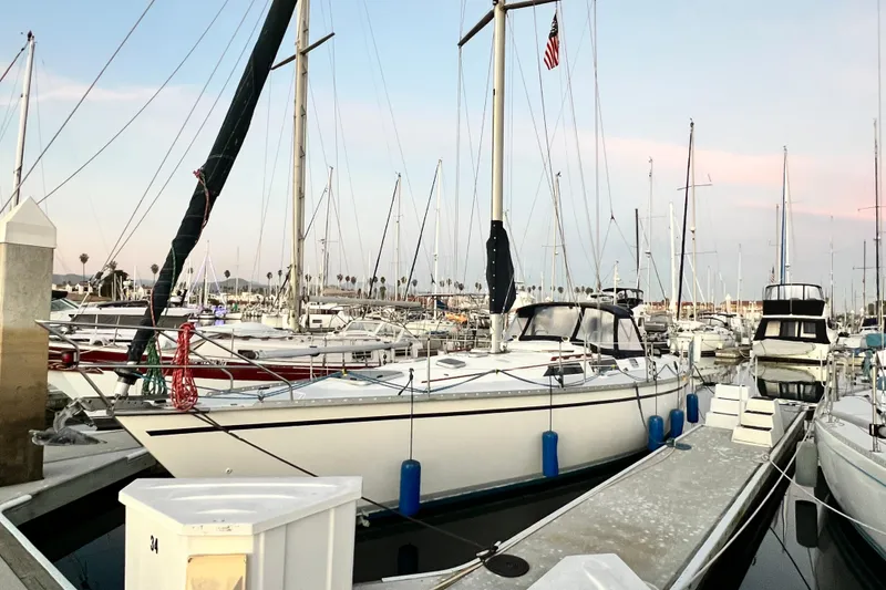 The Image of Sailboat Hunter Legend 40, 1990 model, docked in a marina at sunset. - 0