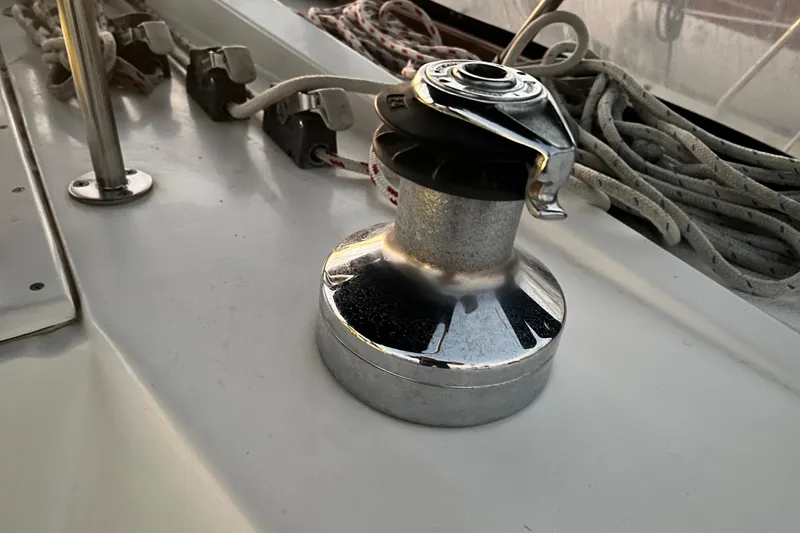 Slide: The Image of Winch on 1990 Hunter Legend 40 sailboat deck with ropes and cleats. - 24