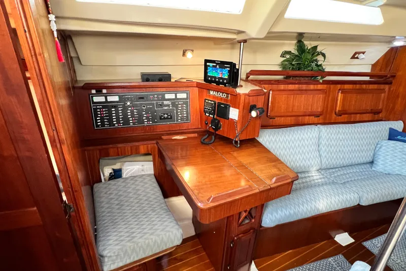Slide: The Image of Interior of 1990 Hunter Legend 40 sailboat with navigation station and seating area. - 28