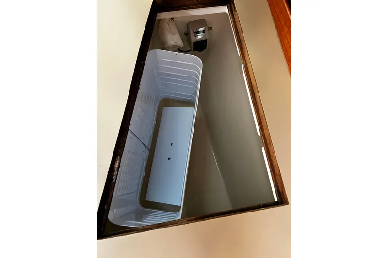 Slide: The Image of Interior view of a 1990 Hunter Legend 40 boat storage compartment. - 31