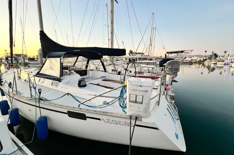 Slide: The Image of Sailboat docked at marina, 1990 Hunter Legend 40, calm water, sunset background. - 4