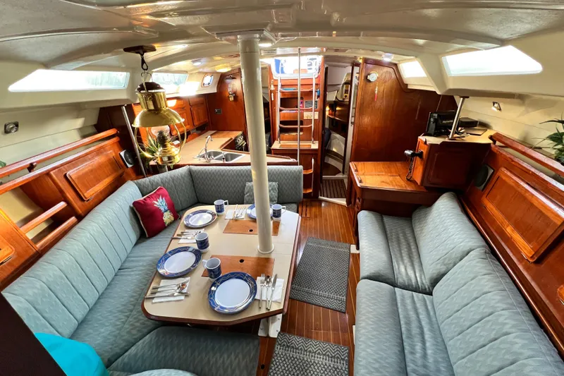 Slide: The Image of Interior of a 1990 Hunter Legend 40 sailboat with cozy seating and dining area. - 42