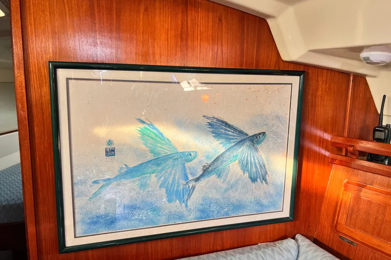 Slide: The Image of Framed artwork of flying fish inside a 1990 Hunter Legend 40 sailboat cabin. - 43