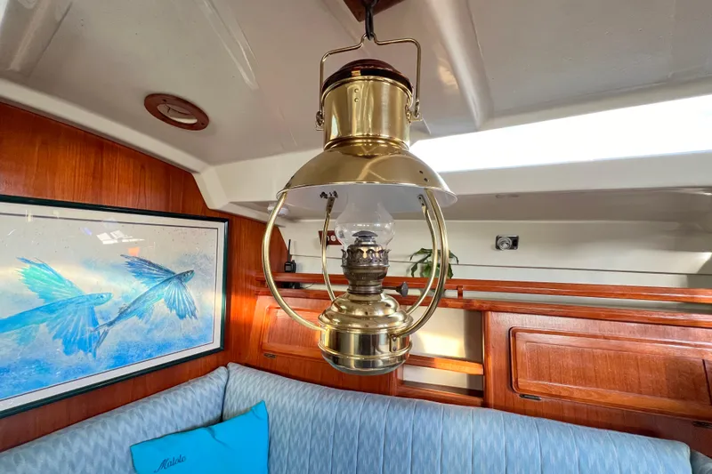 Slide: The Image of Vintage brass lantern in 1990 Hunter Legend 40 yacht interior with nautical artwork. - 44