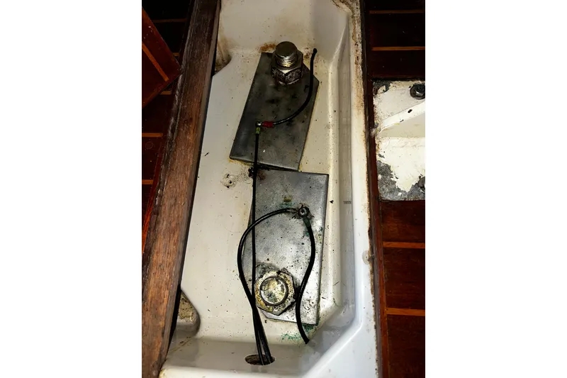 Slide: The Image of Interior view of a 1990 Hunter Legend 40 sailboat, showing wiring and metal components. - 53