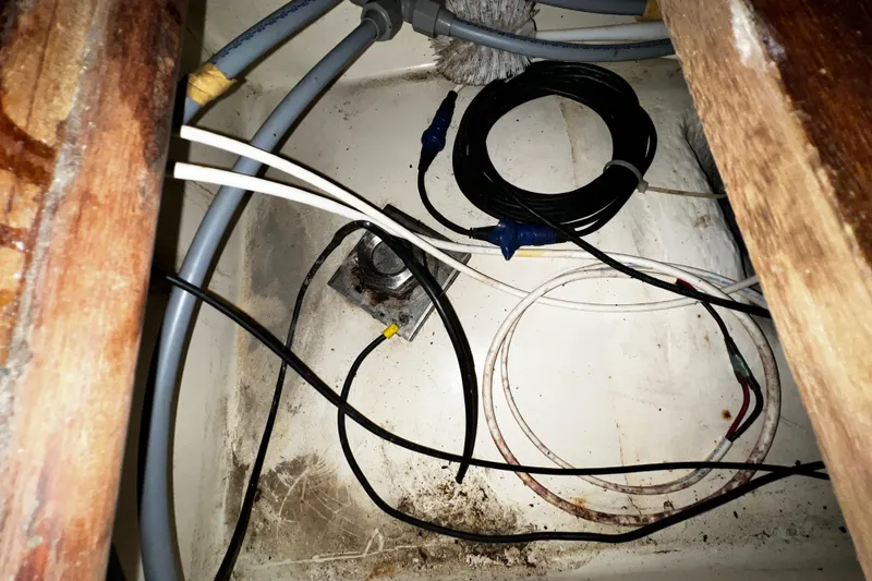 Slide: The Image of Wiring and cables inside a 1990 Hunter Legend 40 boat compartment. - 54