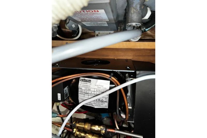 Slide: The Image of Electrical components inside a 1990 Hunter Legend 40 boat, featuring wiring and labels. - 56