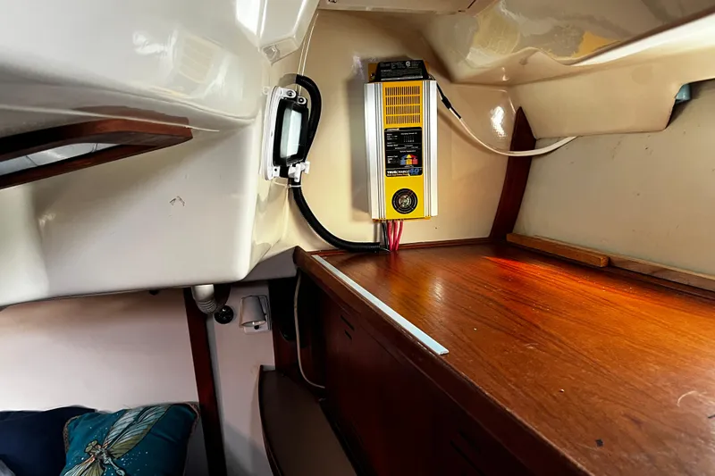 Slide: The Image of Interior of a 1990 Hunter Legend 40 sailboat with electrical panel and wooden surfaces. - 57