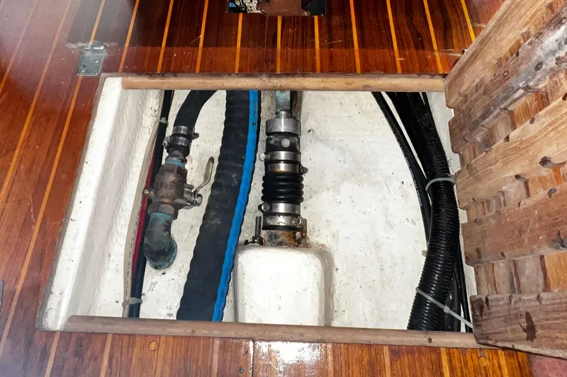 Slide: The Image of Bilge area of 1990 Hunter Legend 40 sailboat with visible plumbing and hoses. - 58