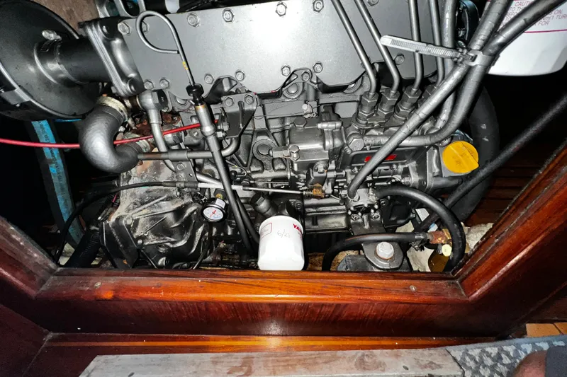 Slide: The Image of Engine compartment of a 1990 Hunter Legend 40 sailboat, showcasing mechanical components. - 59