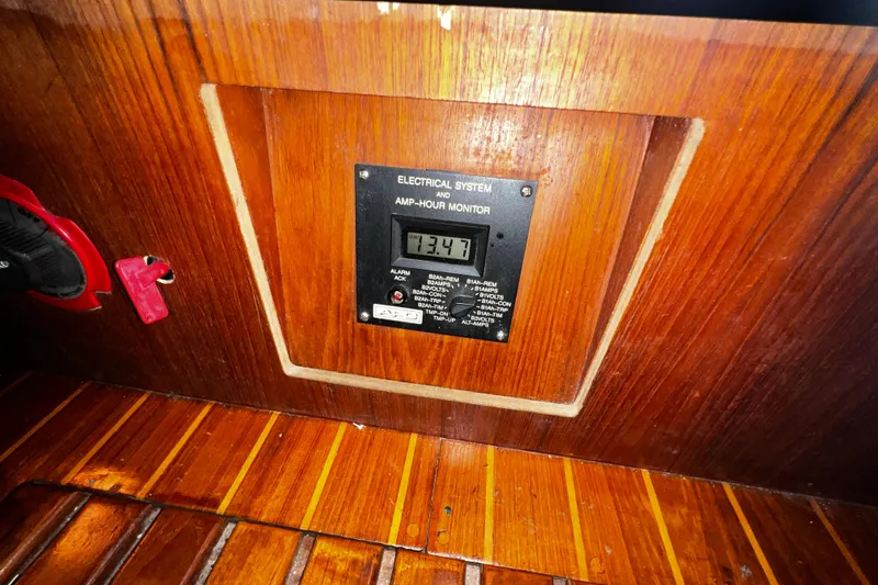 Slide: The Image of Amp-hour monitor on 1990 Hunter Legend 40 yacht, wooden panel background. - 61