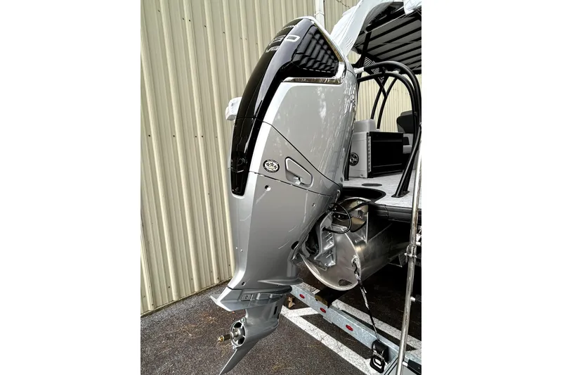 Slide: The Image of 2026 Godfrey Monaco 255 SDC boat with sleek outboard motor design. - 10