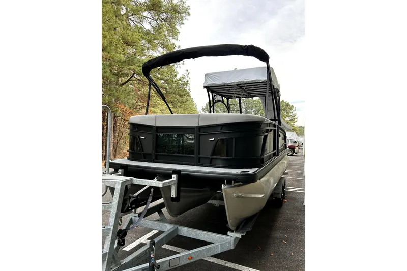 Slide: The Image of 2026 Godfrey Monaco 255 SDC pontoon boat on trailer, parked outdoors. - 2