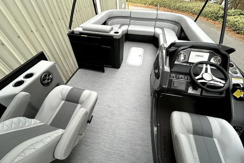 Slide: The Image of 2026 Godfrey Monaco 255 SDC boat interior with modern seating and steering console. - 5