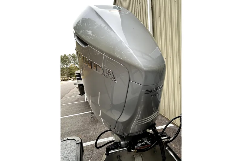Slide: The Image of Silver Honda outboard motor on a 2026 Godfrey Monaco 255 SDC boat. - 6