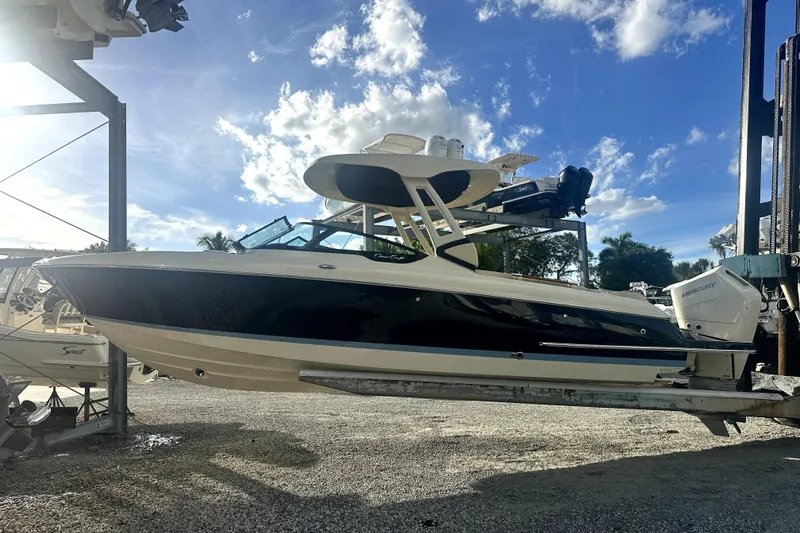 Slide: The Image of 2026 Chris-Craft Sportster 28 boat on lift under blue sky. - 1