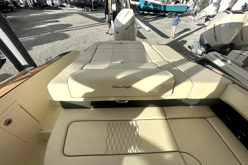 Slide: The Image of 2026 Chris-Craft Sportster 28 boat interior with beige seating and Mercury engines. - 7