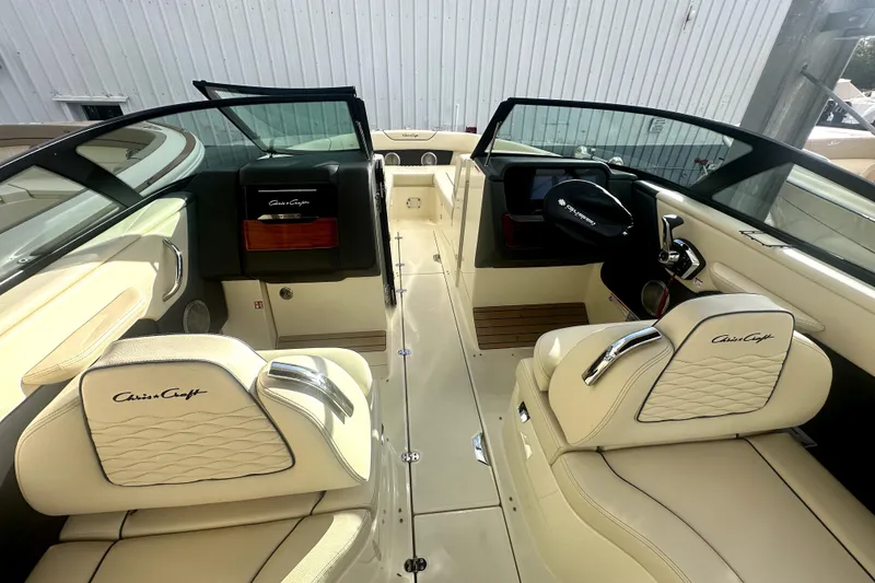 Slide: The Image of 2026 Chris-Craft Sportster 28 interior with luxurious cream seating and sleek dashboard design. - 9
