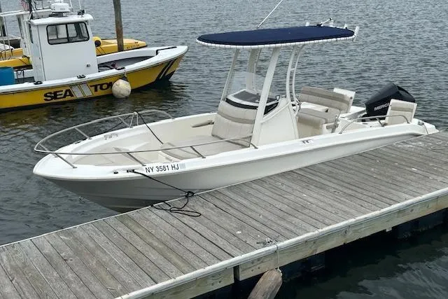 Slide: The Image of 2023 Whaler 220 Dauntless boat docked, featuring a sleek design and modern amenities. - 3