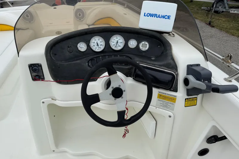 Slide: The Image of 2003 VIP Deckliner 224 boat dashboard with steering wheel and gauges. - 14