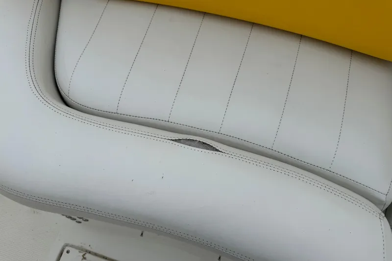 Slide: The Image of White leather seat with visible stitching on a 2003 VIP Deckliner 224 boat. - 23