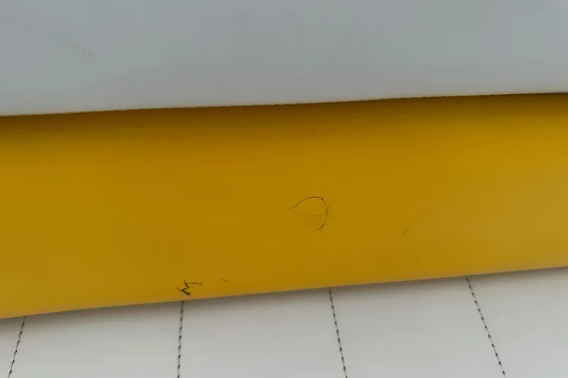 Slide: The Image of Close-up of a 2003 VIP Deckliner 224 boat seat with visible cracks. - 25