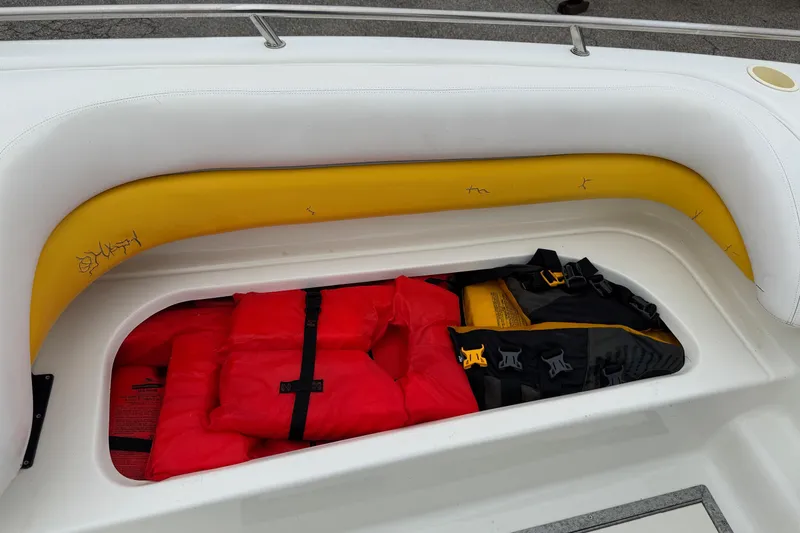 Slide: The Image of Storage compartment on 2003 VIP Deckliner 224 boat with life jackets and safety gear. - 36