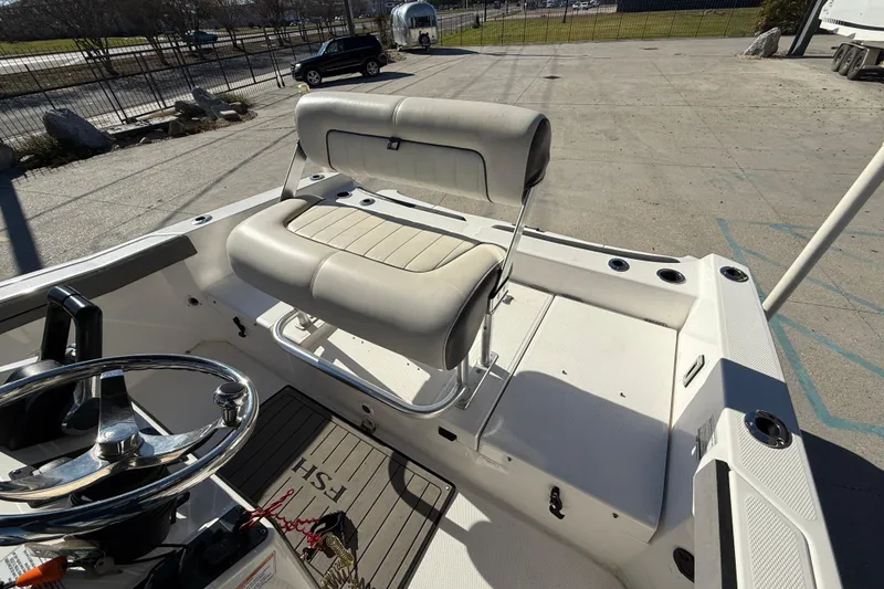 Slide: The Image of 2019 Yamaha Boats 210 FSH Sport interior with steering wheel and seating. - 10