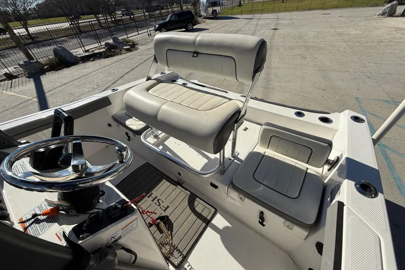 Slide: The Image of 2019 Yamaha Boats 210 FSH Sport interior with seating and steering wheel. - 11
