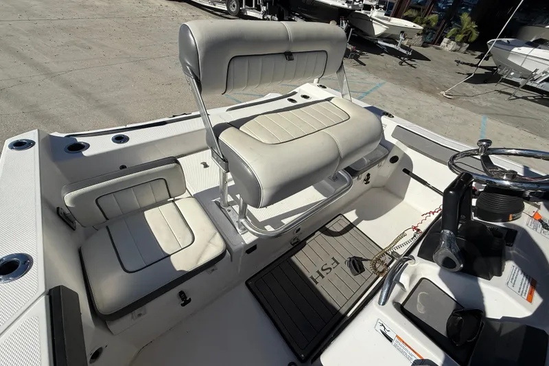 Slide: The Image of 2019 Yamaha Boats 210 FSH Sport interior with seating and steering wheel. - 14