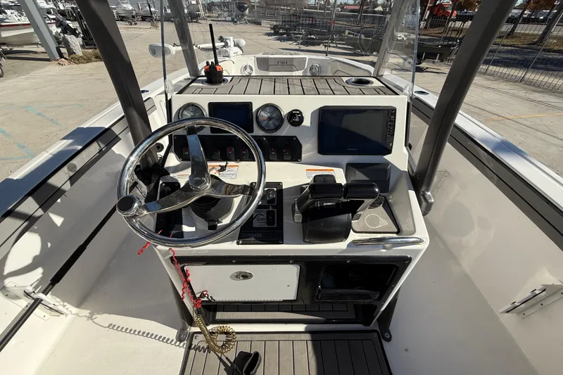 Slide: The Image of 2019 Yamaha Boats 210 FSH Sport dashboard with steering wheel and controls. - 15