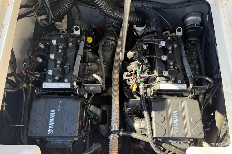 Slide: The Image of Engine compartment of a 2019 Yamaha Boats 210 FSH Sport, showcasing dual Yamaha TR-1 engines. - 20