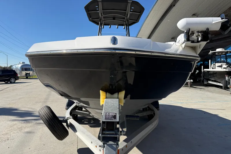 Slide: The Image of 2019 Yamaha Boats 210 FSH Sport on trailer, parked outdoors under clear sky. - 3
