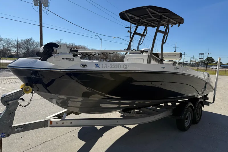 Slide: The Image of 2019 Yamaha Boats 210 FSH Sport on trailer, featuring Minn Kota trolling motor. - 4
