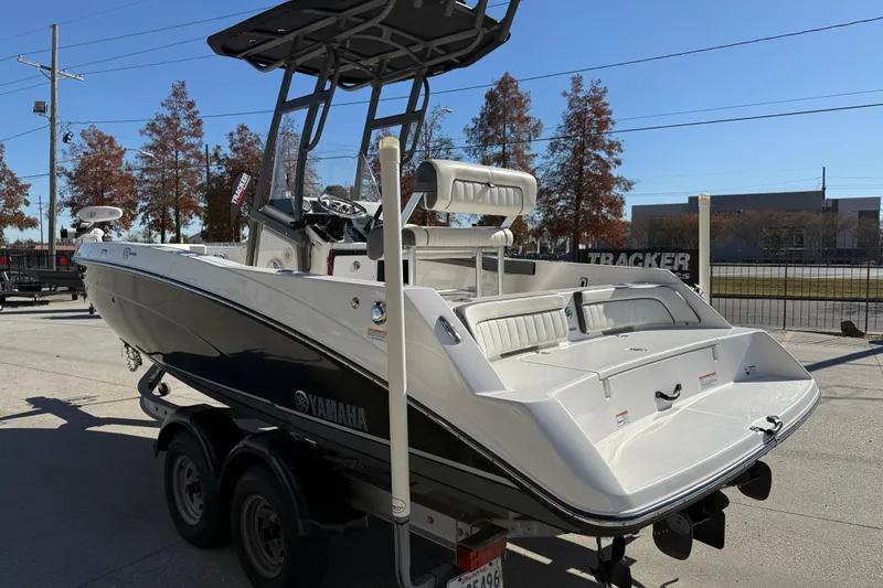Slide: The Image of 2019 Yamaha Boats 210 FSH Sport on trailer, parked outdoors, sunny day. - 5