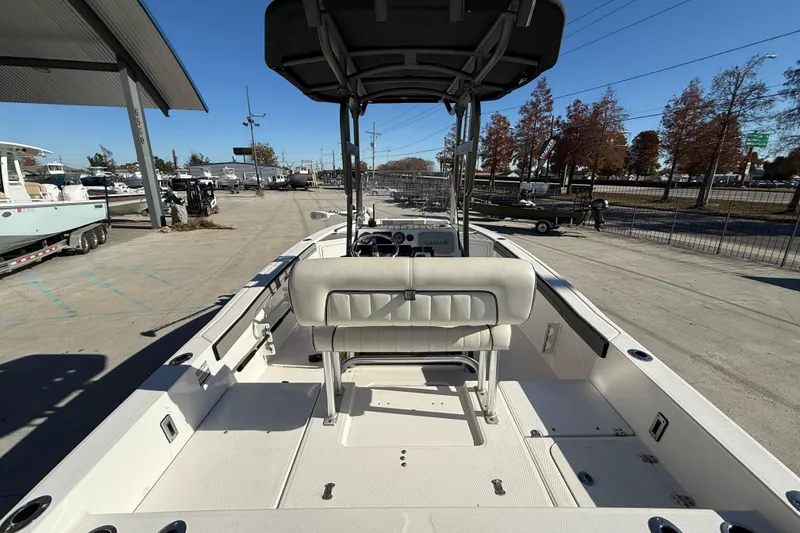 Slide: The Image of 2019 Yamaha Boats 210 FSH Sport, spacious deck view at a marina. - 8