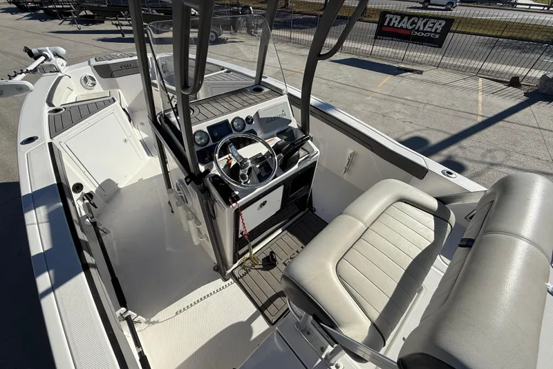 Slide: The Image of 2019 Yamaha Boats 210 FSH Sport interior with steering console and seating. - 9