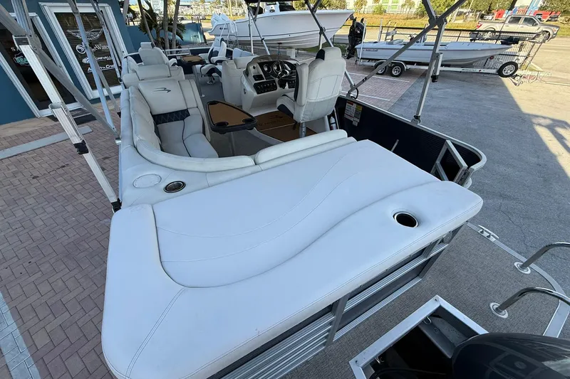Slide: The Image of 2019 Bennington R 25 RL pontoon boat with luxurious white seating and helm. - 10