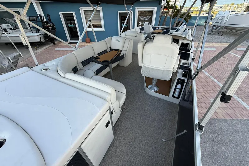 Slide: The Image of 2019 Bennington R 25 RL pontoon boat interior with plush seating and helm station. - 11