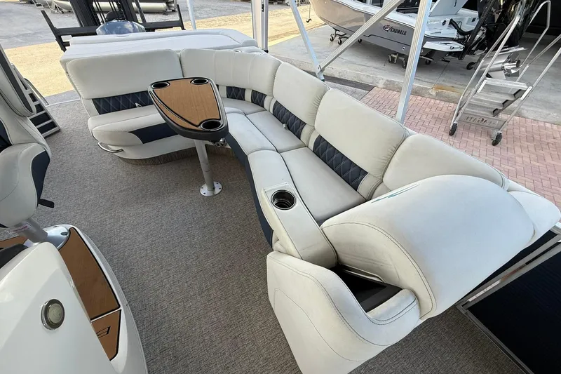 Slide: The Image of 2019 Bennington R 25 RL boat interior with plush seating and table. - 14